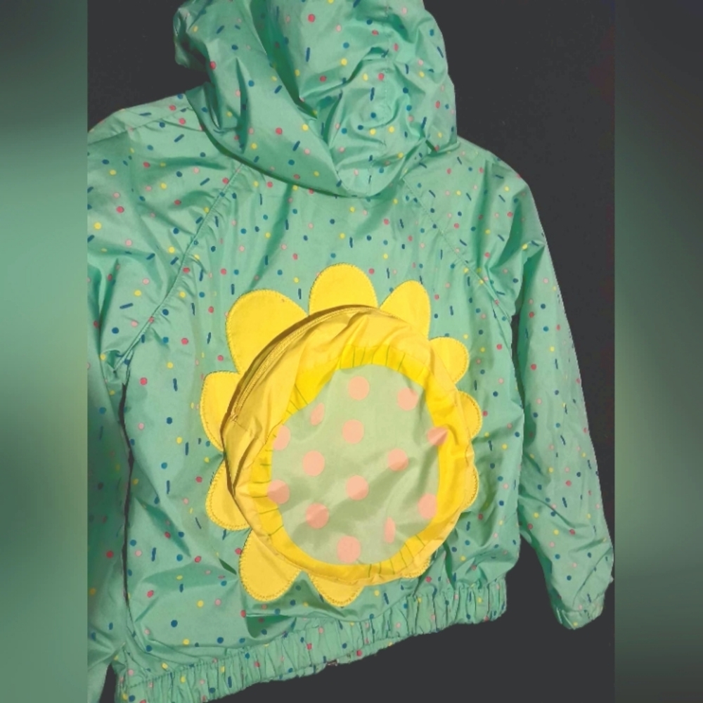 Raincoat with built in backpack